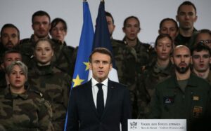 French President Emmanuel Macron sings the national anthem after delivering his New Year address to the French Army at the Mont-de-Marsan air base, southwestern France, on January 20, 2023. (Photo by Bob Edme / POOL / AFP)